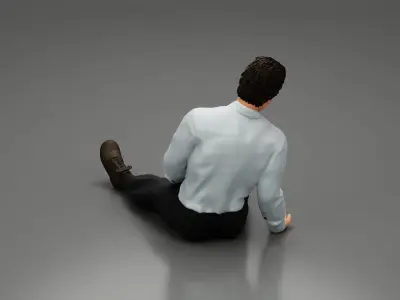 Accident of a male worker sitting on the floor with an injured 3D print model