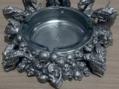 an ashtray with dragons and skulls 3D print model