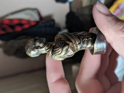 The engineer person holding brass figurine 3D print model