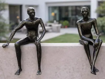 Two unique seated human sculpture models Low-poly 3D model