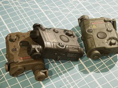 ANPEQ15 three military devices on cutting mat Low-poly 3D model