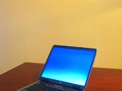 youman laptop on wooden table Free 3D model